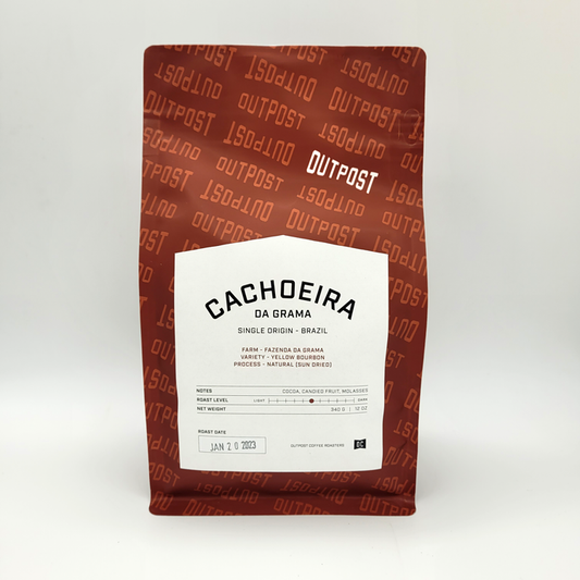 A package of Outpost brand coffee, labeled 'CACHOEIRA DA GRAMA - SINGLE ORIGIN - BRAZIL', with details about the coffee's origin, region, farm, variety, altitude, process, and roast.